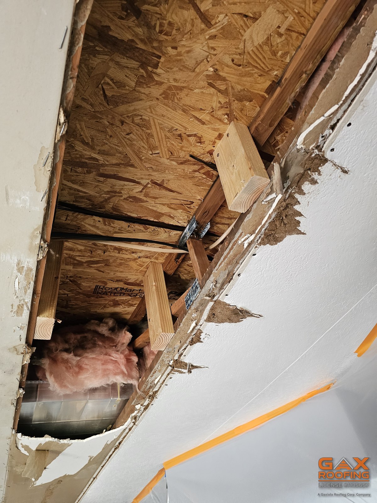 Collapsed ceiling and exposed framing from a long running roof leak in Brea, California
