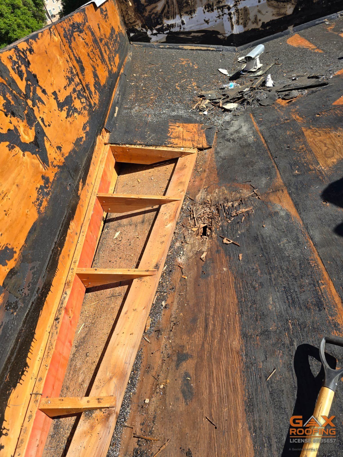 New framing installed in a cut-out section of a Redlands commercial roof deck