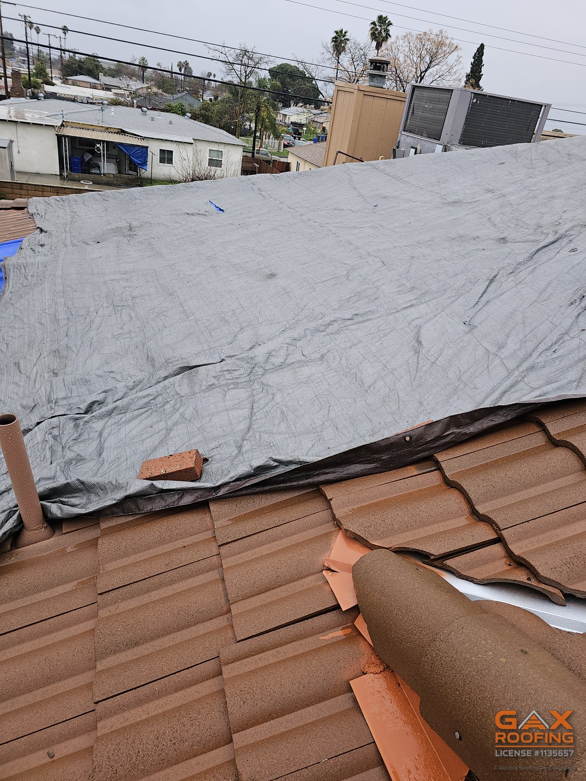 Emergency tarp over an unfinished tile roof in Tustin, California