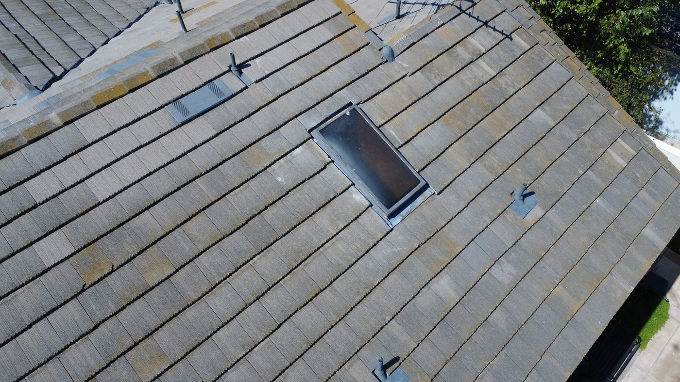 Aerial detail of a skylight set in new tile by GAX Roofing