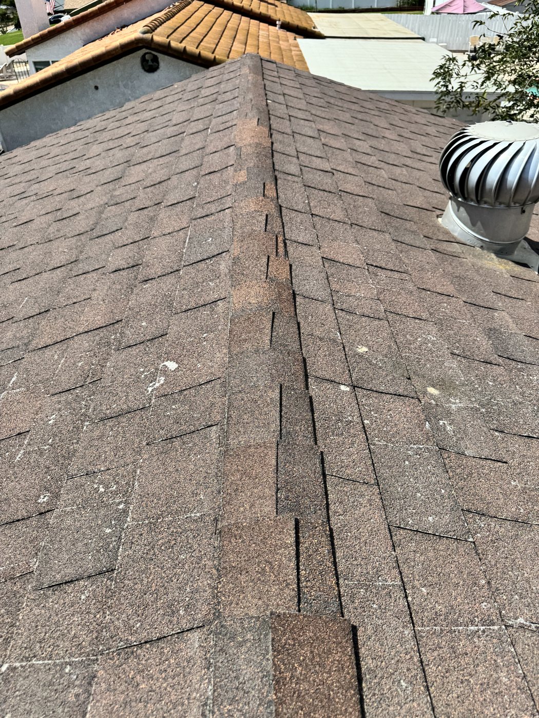Cut field shingles used as ridge caps on a Jurupa Valley roof