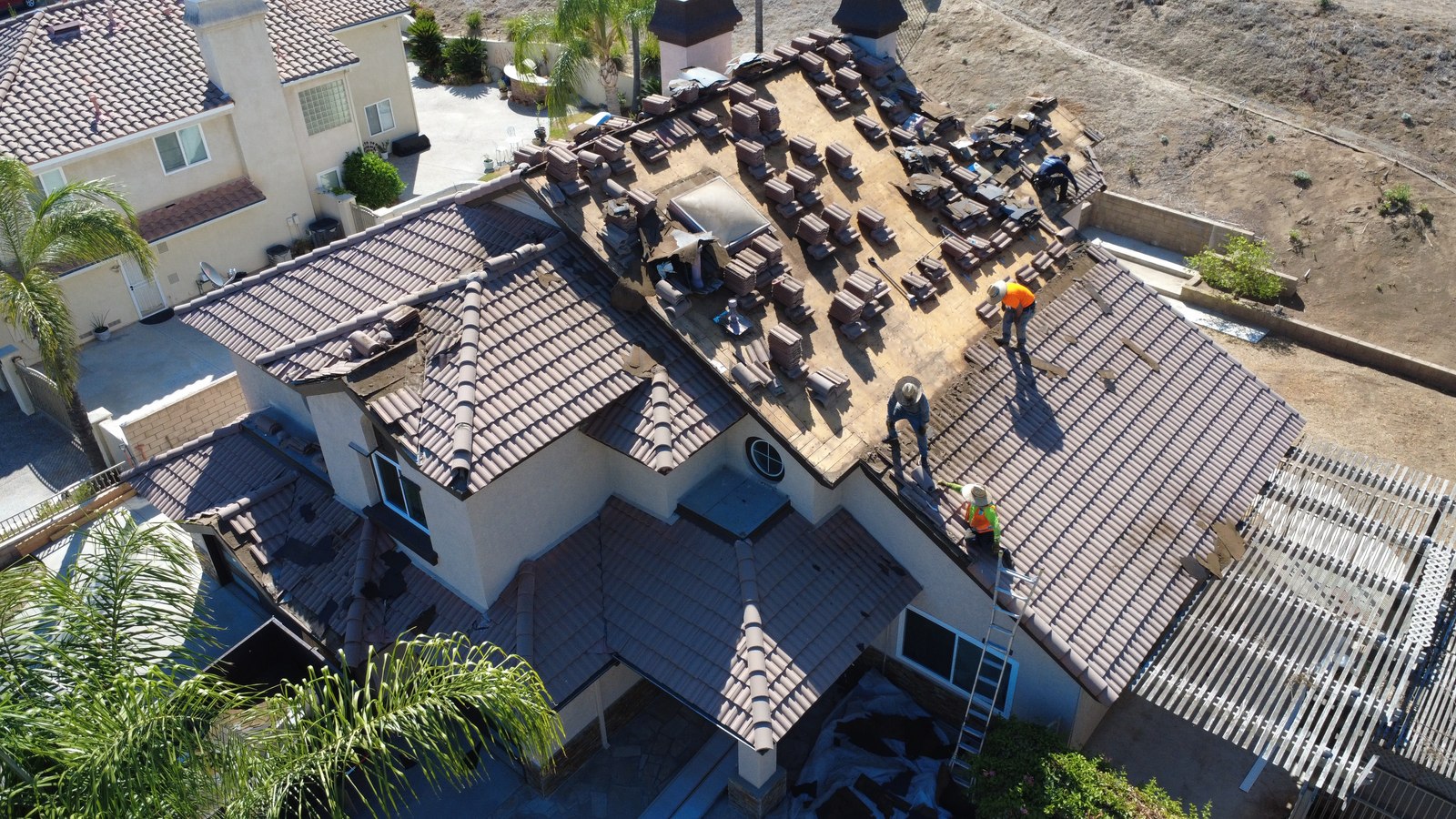 Aerial view of tiles stacked and felt stripped during a lift and relay in Riverside