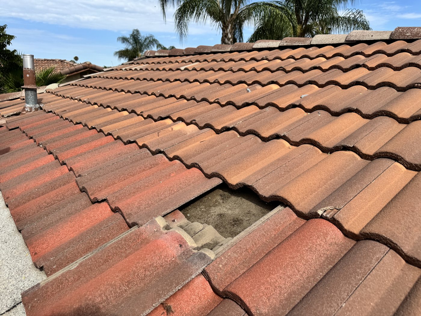 Slipped tiles and exposed underlayment on a Riverside tile roof