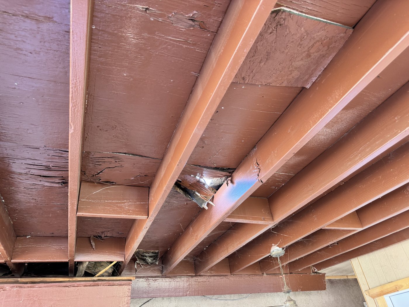 Water damaged rafters found below a leaking spot-nailed tile roof in Riverside