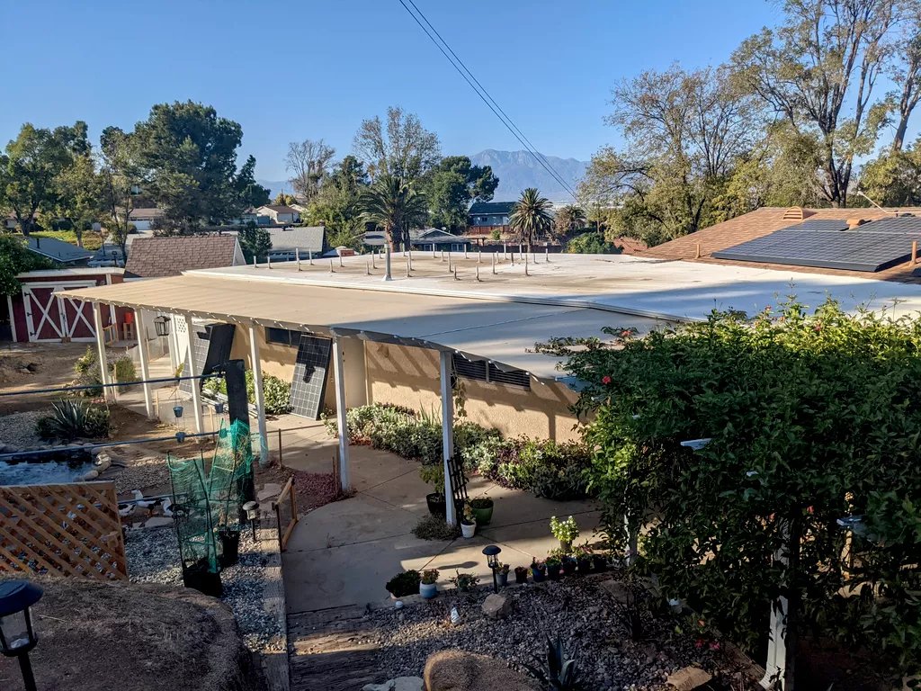 Completed flat roof installation with San Gabriel Mountains GAX Roofing