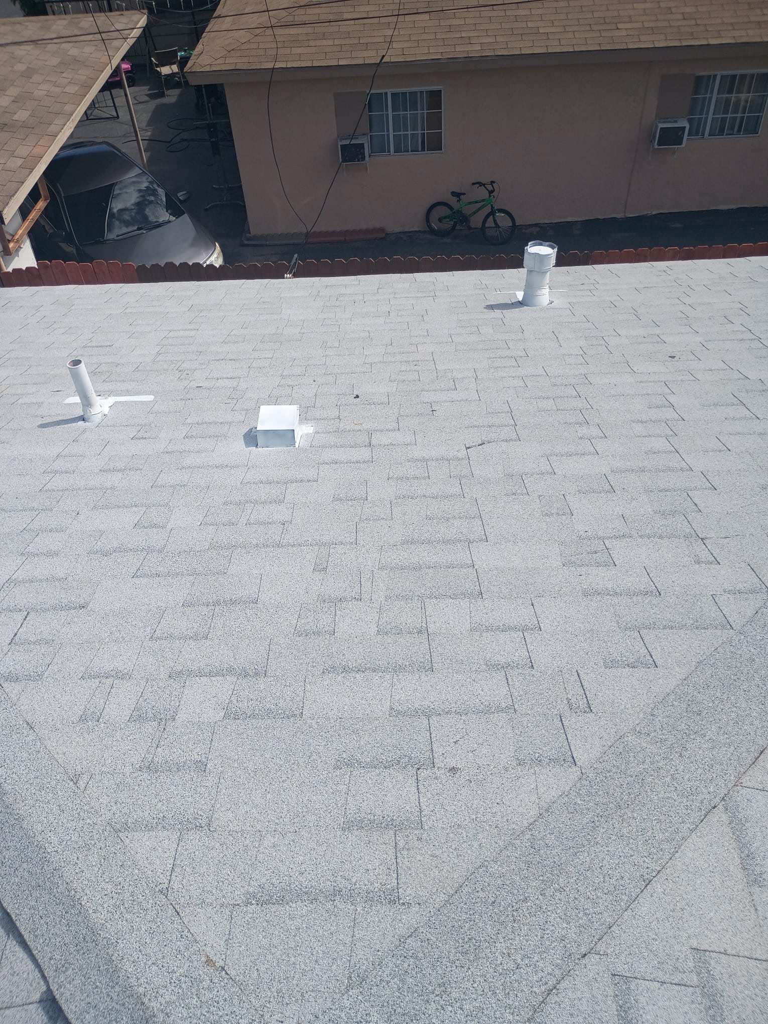 Completed tan shingle roof with ridge cap