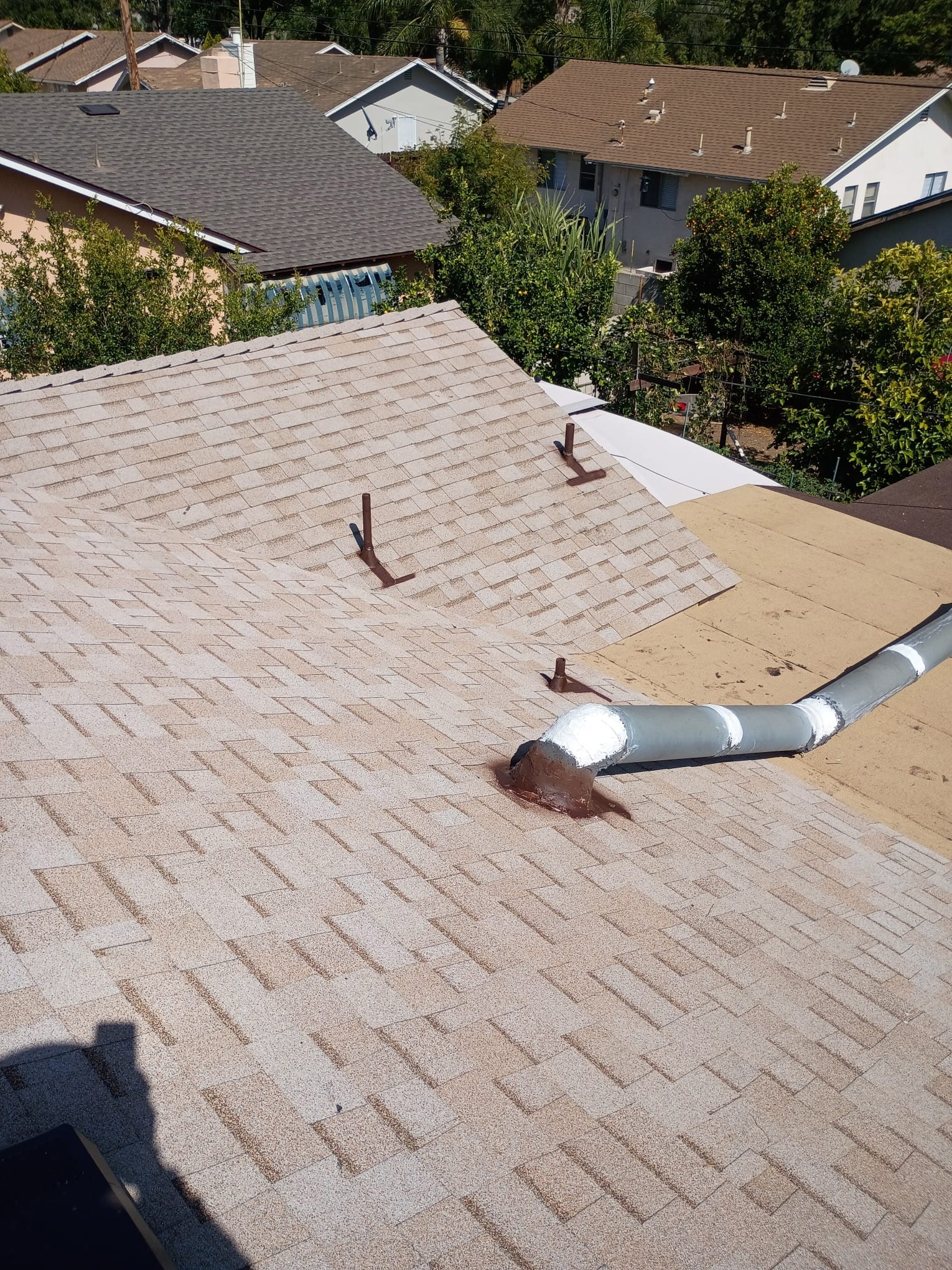 Completed shingle roof pipe boots and ridge