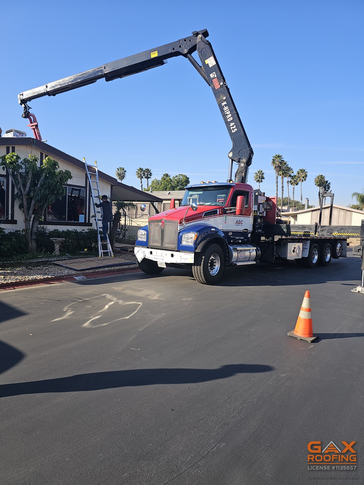 Crane lifting materials onto a mobile home roof in Huntington Beach