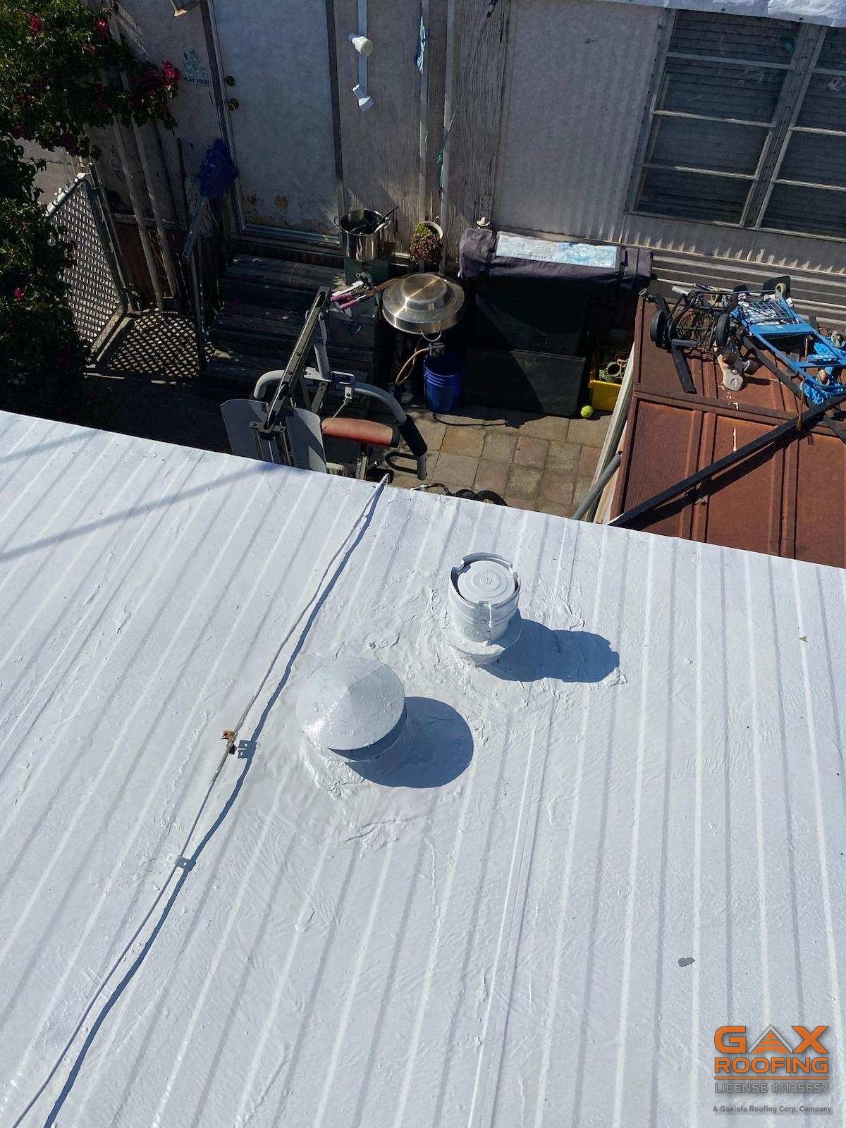 Seams and penetrations sealed under a continuous silicone coating on an Ontario mobile home roof