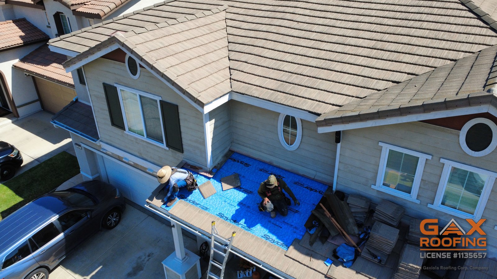Vista a&eacute;rea de una reparaci&oacute;n de techo en Huntington Beach, CA: teja de concreto plana levantada y apilada en la secci&oacute;n del techo del patio, membrana autoadherible Spyder PSU nueva colocada, cami&oacute;n de GAX Roofing en la entrada