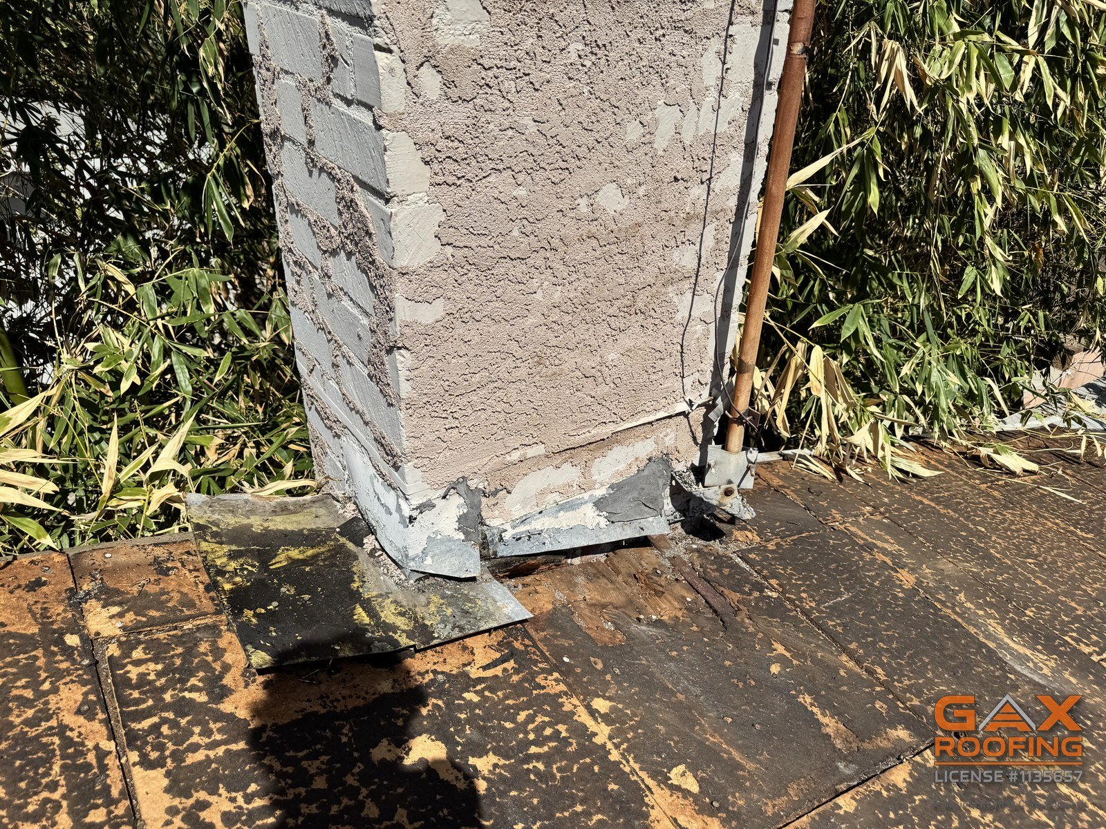 Chimney with the old flashing removed during a roof replacement in Pomona, CA