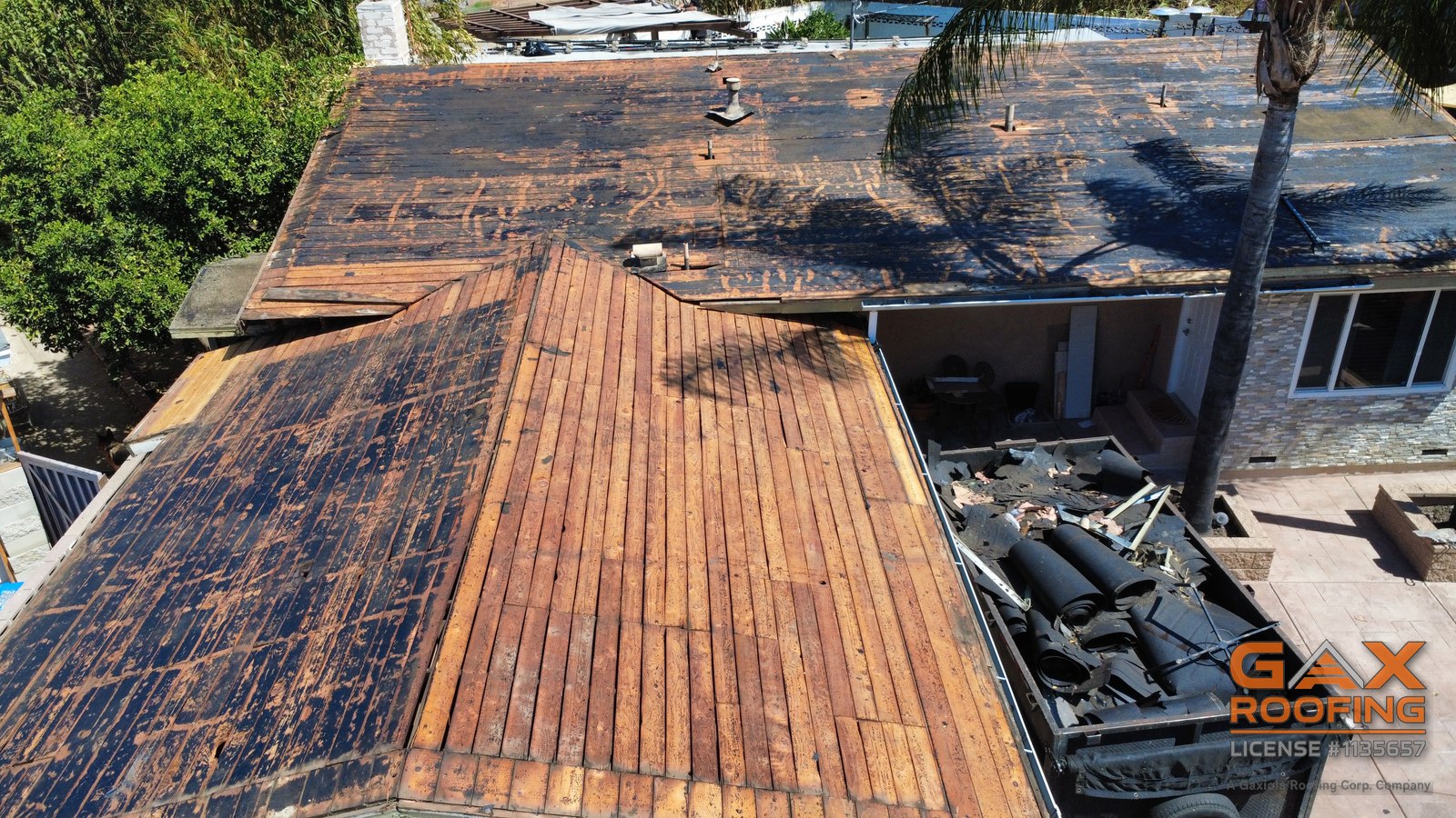 Old roofing loaded out on tear-off day at a Pomona roof replacement by GAX Roofing