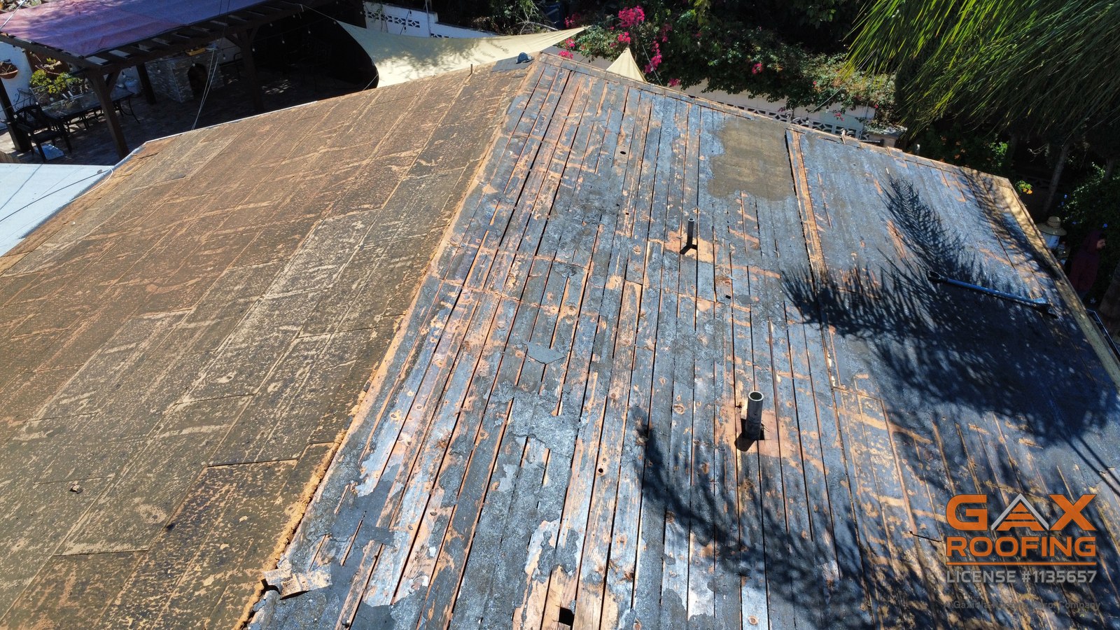 Bare tongue and groove roof deck exposed after tear-off on a Pomona home