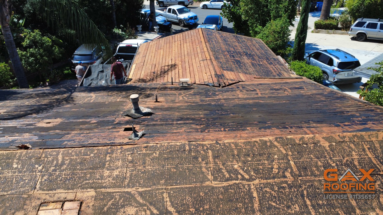 Open roof deck on the Pomona job with the crew working, eaves exposed before new fascia goes on