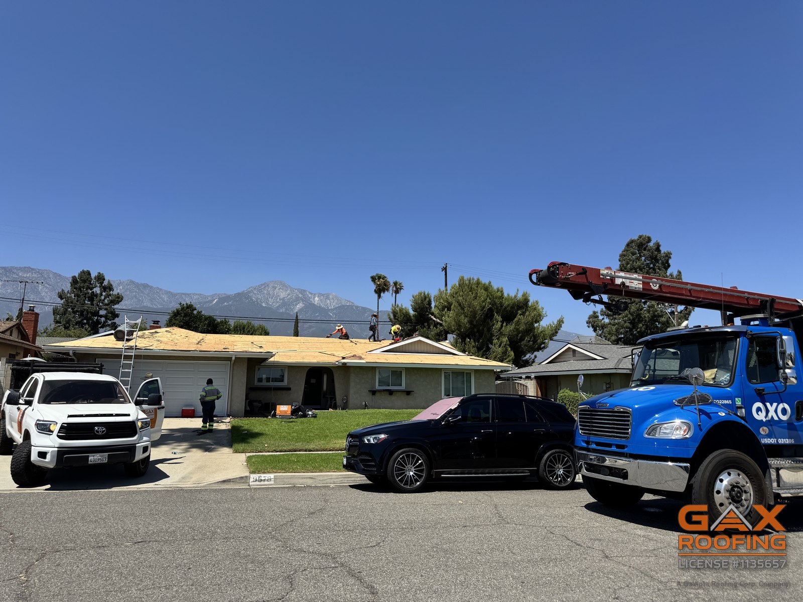 GAX Roofing crew loading a roof with a crane during a replacement in Rancho Cucamonga, CA