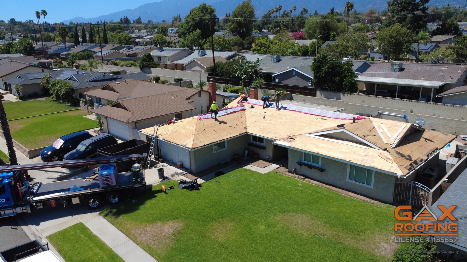 GAX Roofing crew laying underlayment over fresh decking
