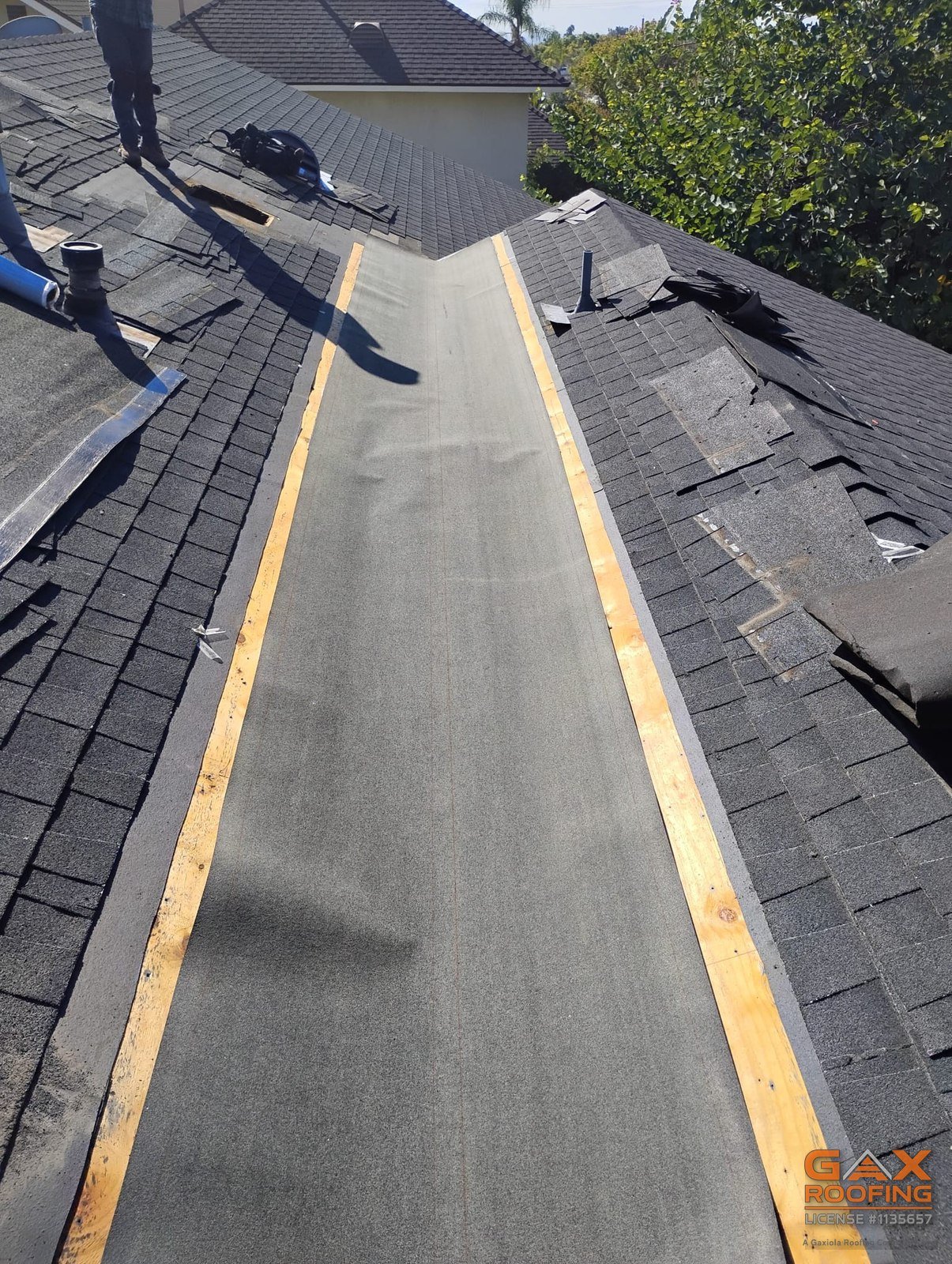 Rebuilt roof valley in San Dimas with new membrane and shingles cut back on both sides