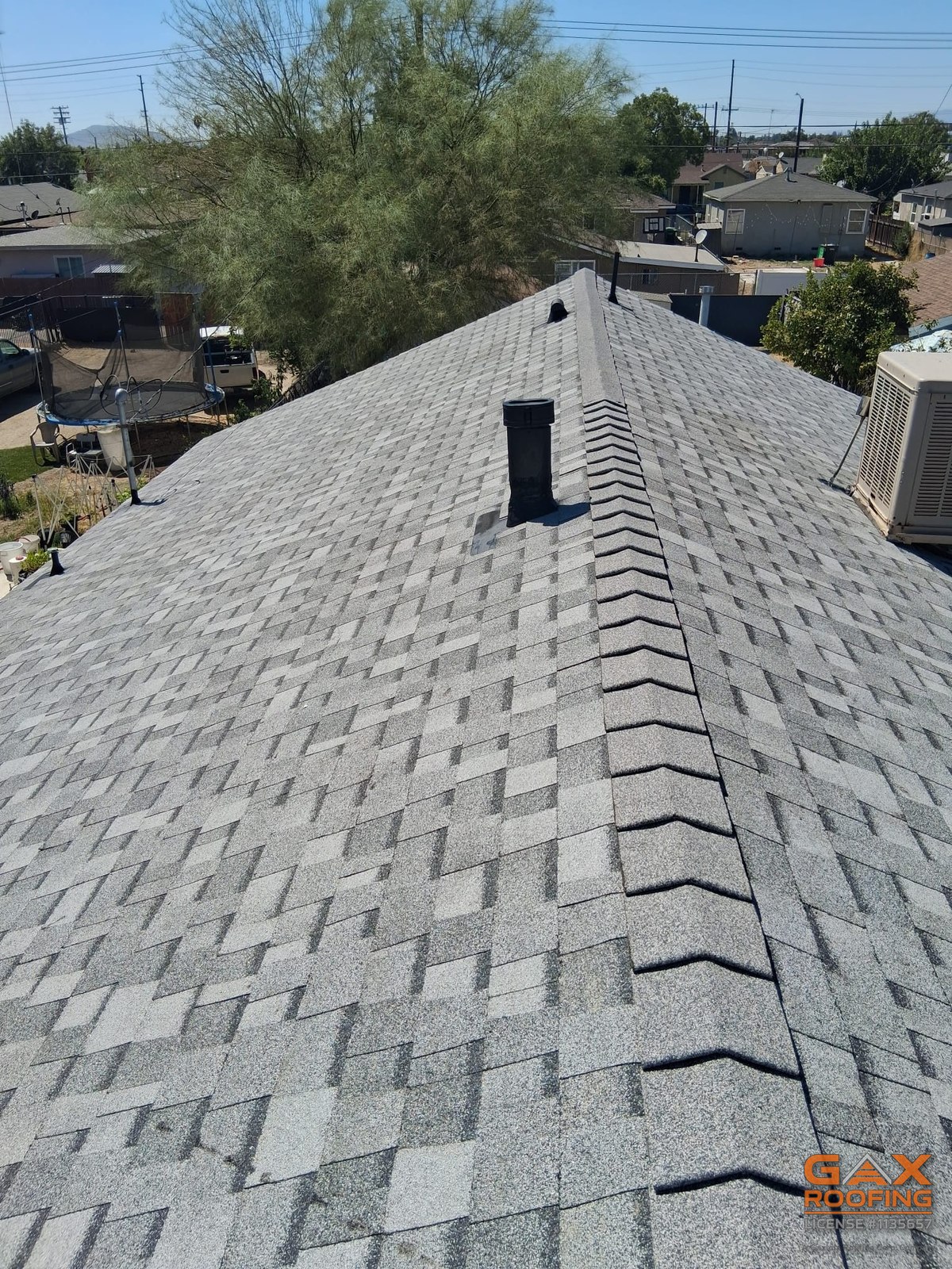 Finished cool-rated shingle roof with new ridge caps after a full GAX Roofing tear-off in Colton CA