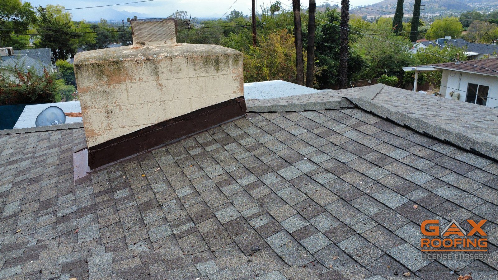 Chimney with its flashing redone on a finished shingle roof replacement in San Bernardino
