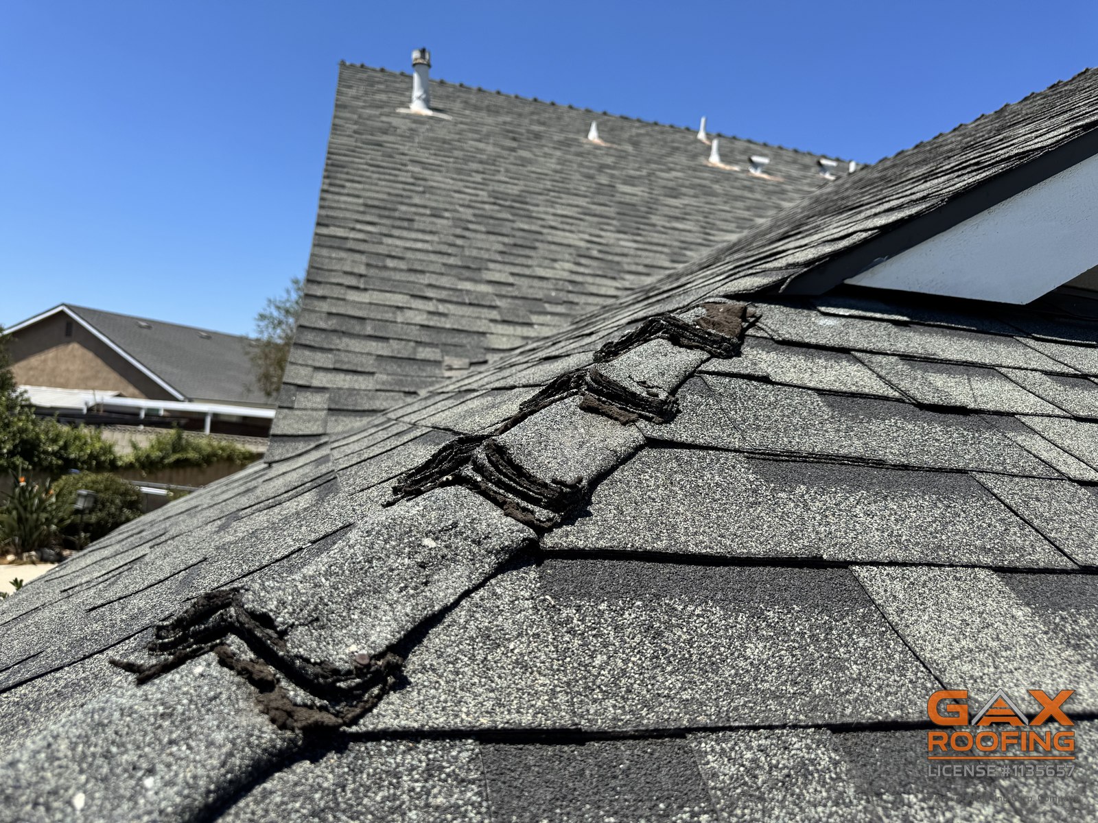 Aged ridge caps cracked down the middle on an Upland roof before replacement