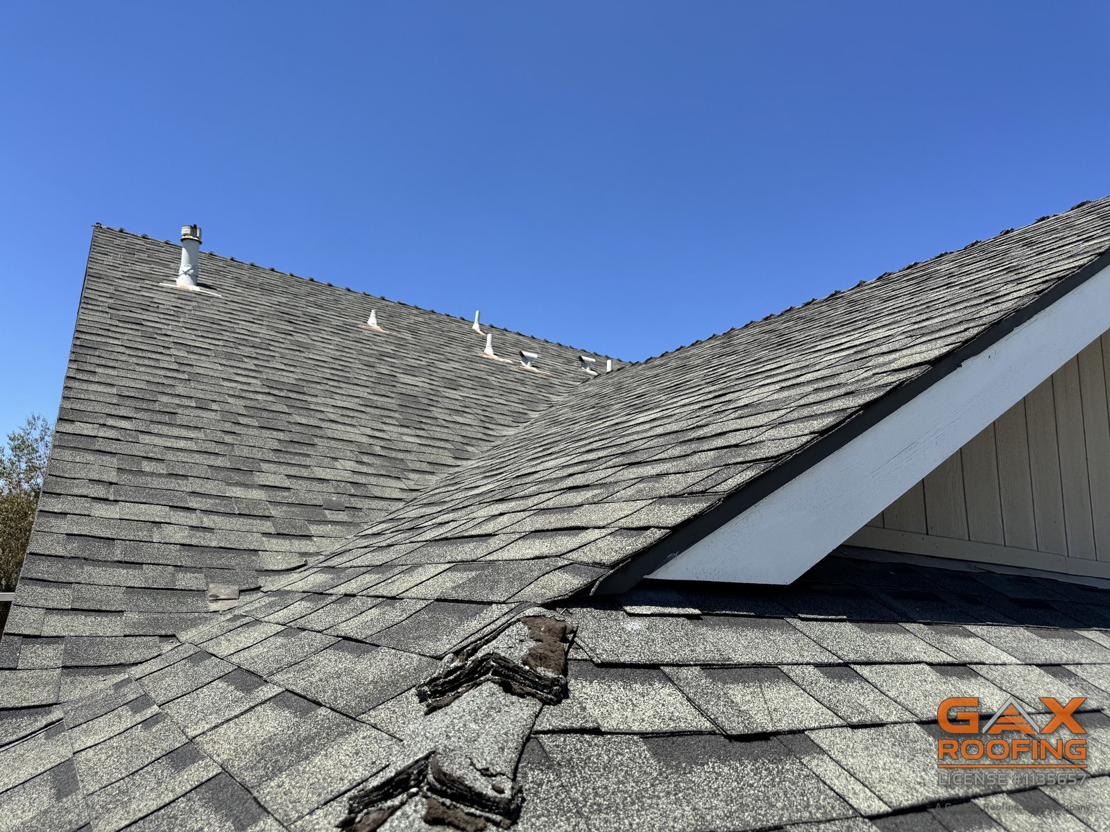 Close view of a split ridge cap exposing the ridge line on the same Upland roof