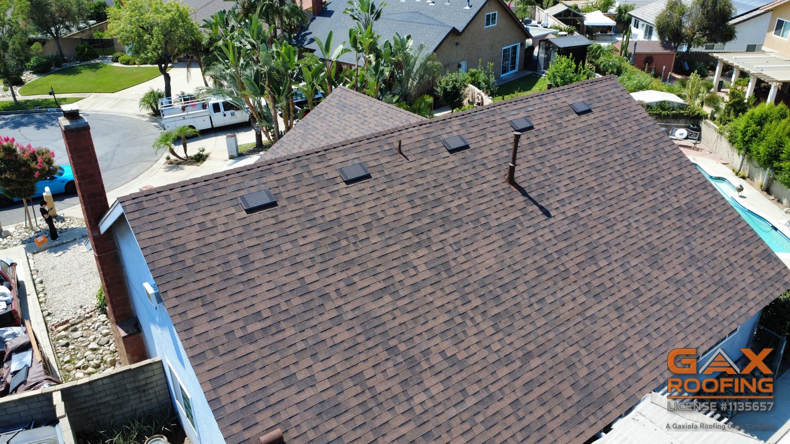 The same Upland roof after full replacement with new dark shingles and new ridge caps