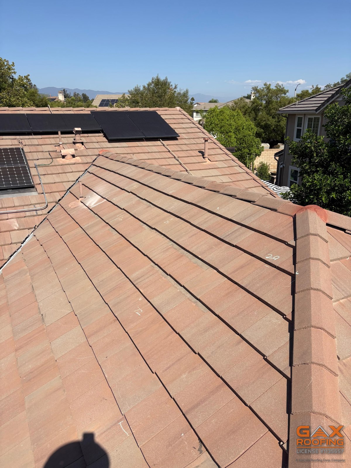 Finished concrete tile section with the solar array behind it on a Rancho Cucamonga roof