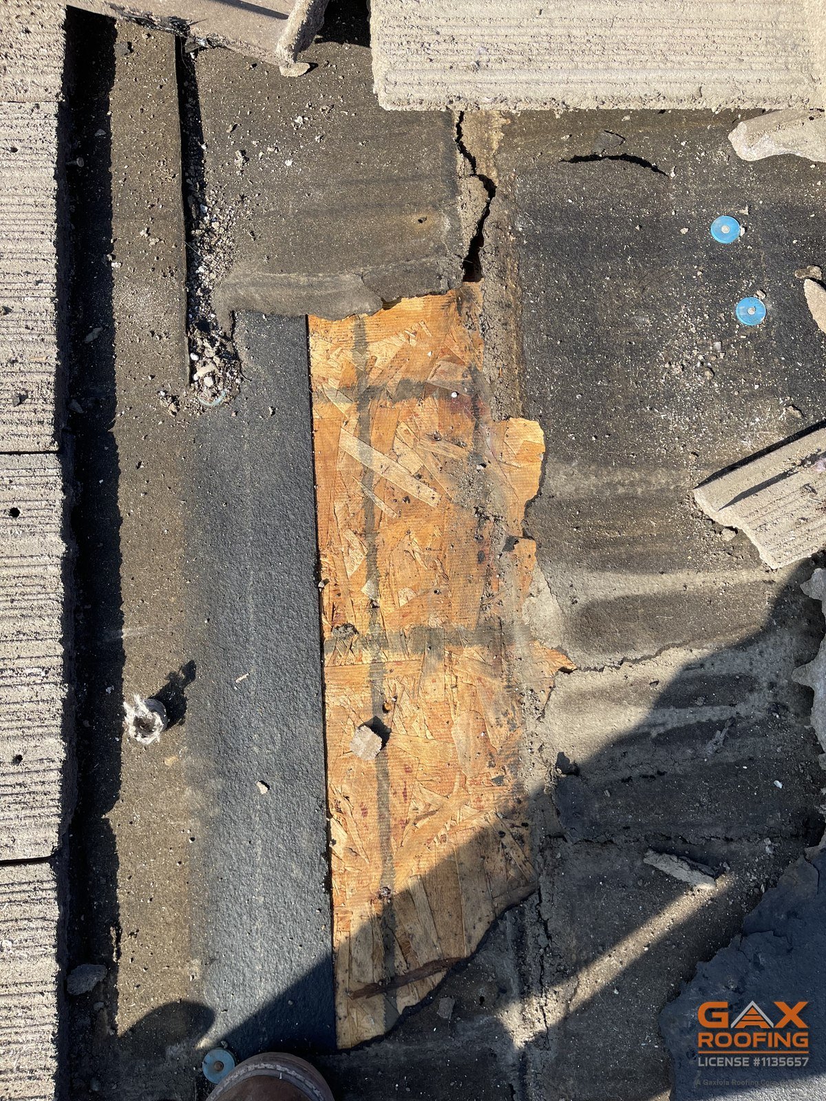Bare roof deck exposed after removing tile and failed underlayment under a solar array in San Dimas