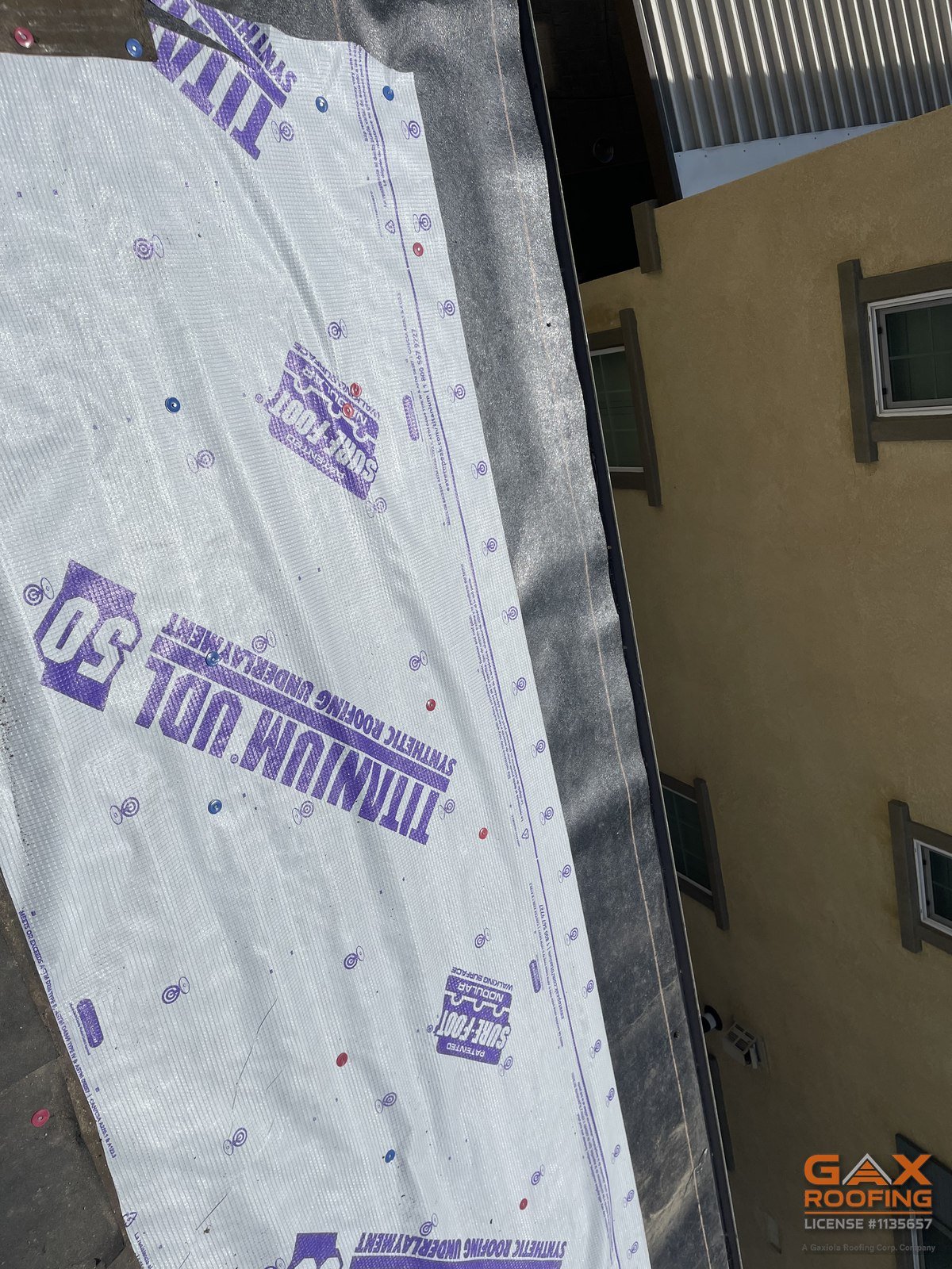 New Titanium UDL50 synthetic underlayment installed over the roof deck under a solar array in San Dimas