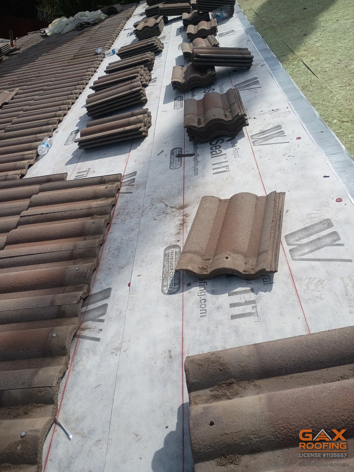 Tile stacked on new Westlake Royal TileSeal HT underlayment during a GAX Roofing tile lift and relay in Norco, California