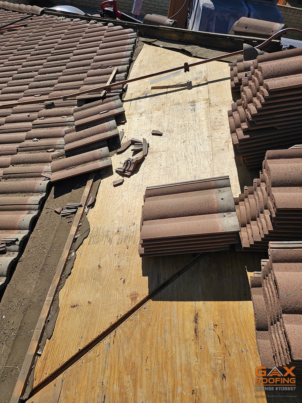 Roof tile staged on exposed decking during a tile repair in Anaheim, California