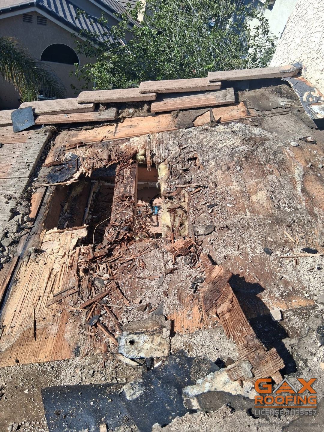 Rotted roof deck with holes found under the tile during a tile roof repair in Hemet, California