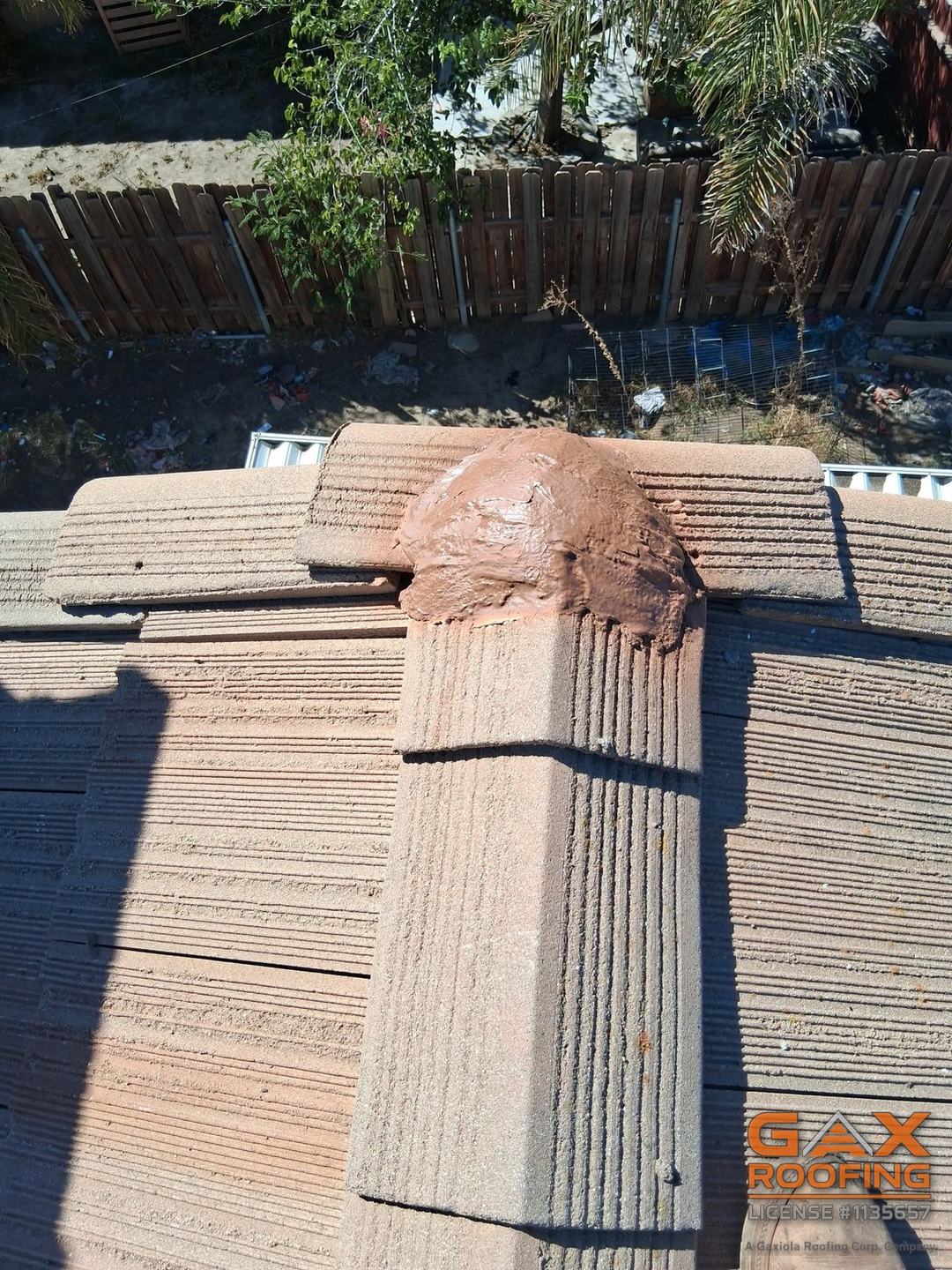 Fresh mortar at the ridge after a tile roof repair in Hemet, California