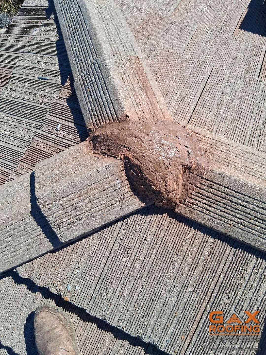 Fresh mortar where the hips meet on a repaired tile roof in Hemet