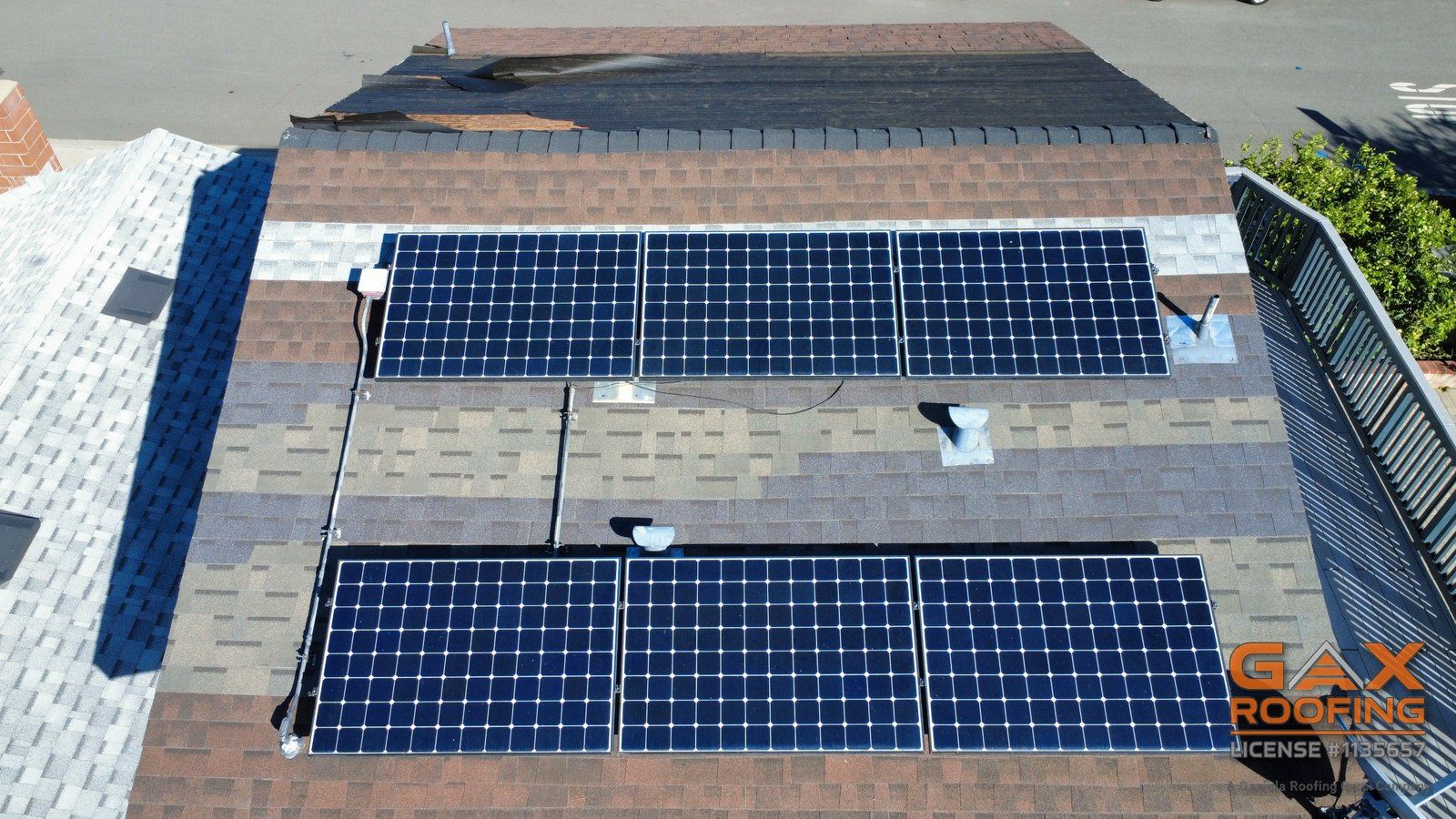 Solar panels on an older, patched shingle roof seen from above during an inspection in Rancho Cucamonga, California