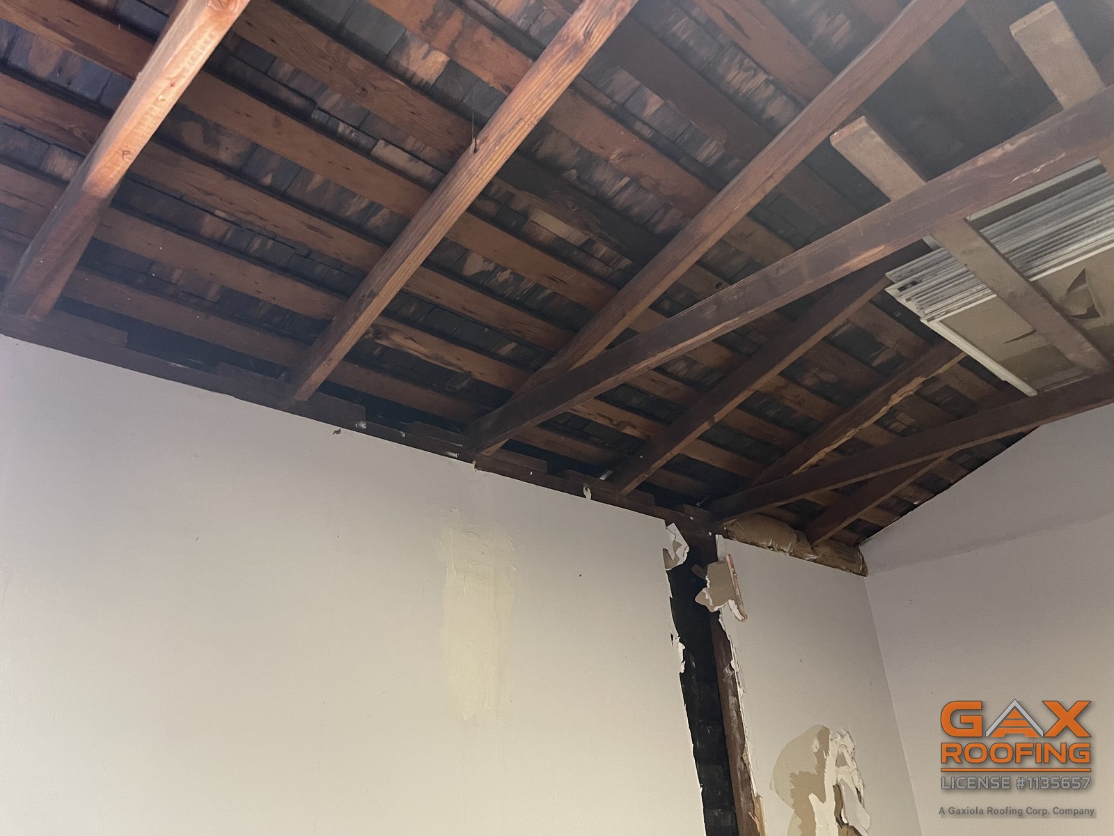 Stained original wood shake visible between rafters from inside a Loma Linda, CA home